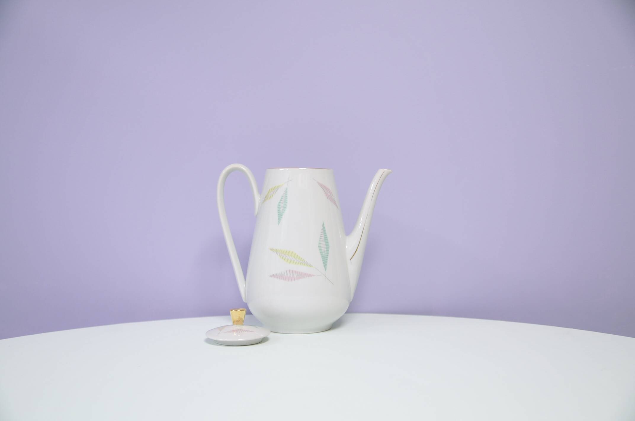 White teapot with pastel flowers