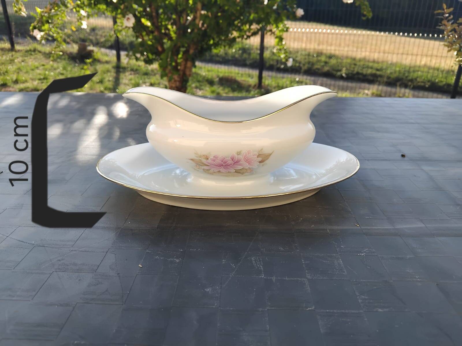 Vintage fine porcelain sauce boat with gold gilding.