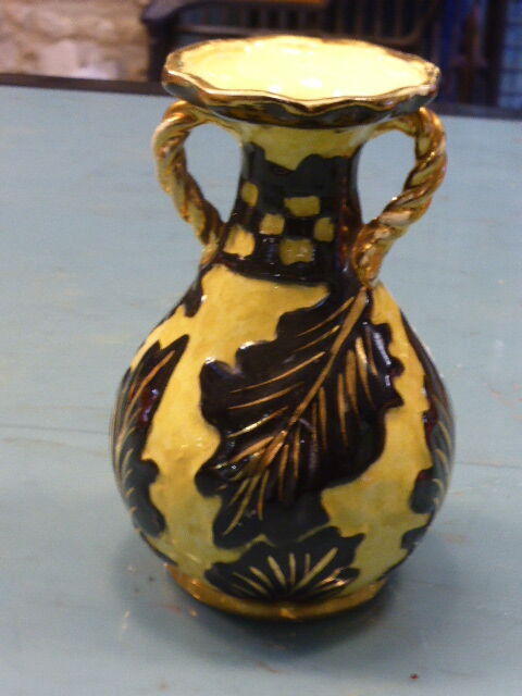 Vase amphora, stamped Vallauris, enamelled ceramic with decorations of black foliage on yellow background, vintage 1950