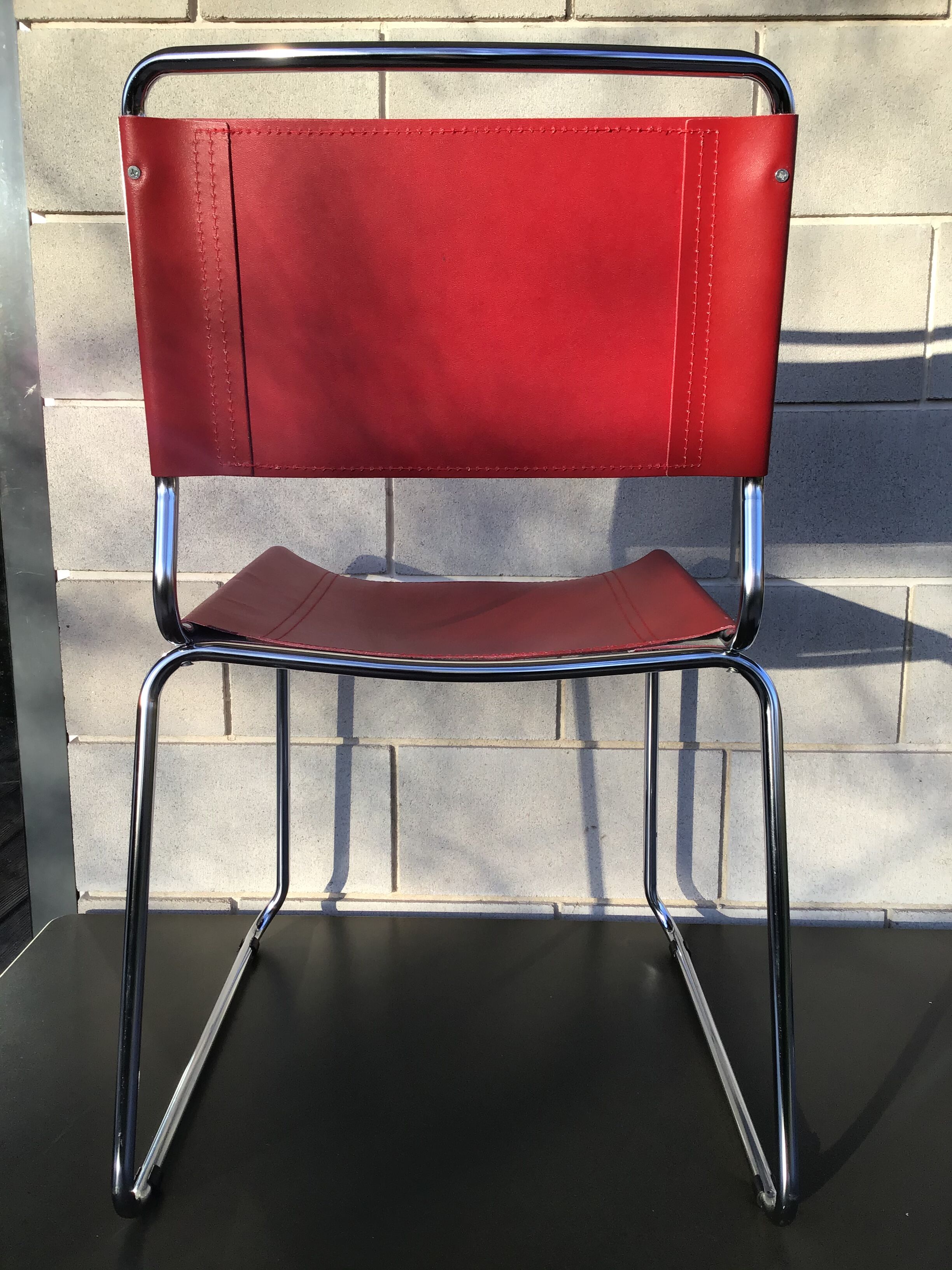 Chrome sled chair and red leather