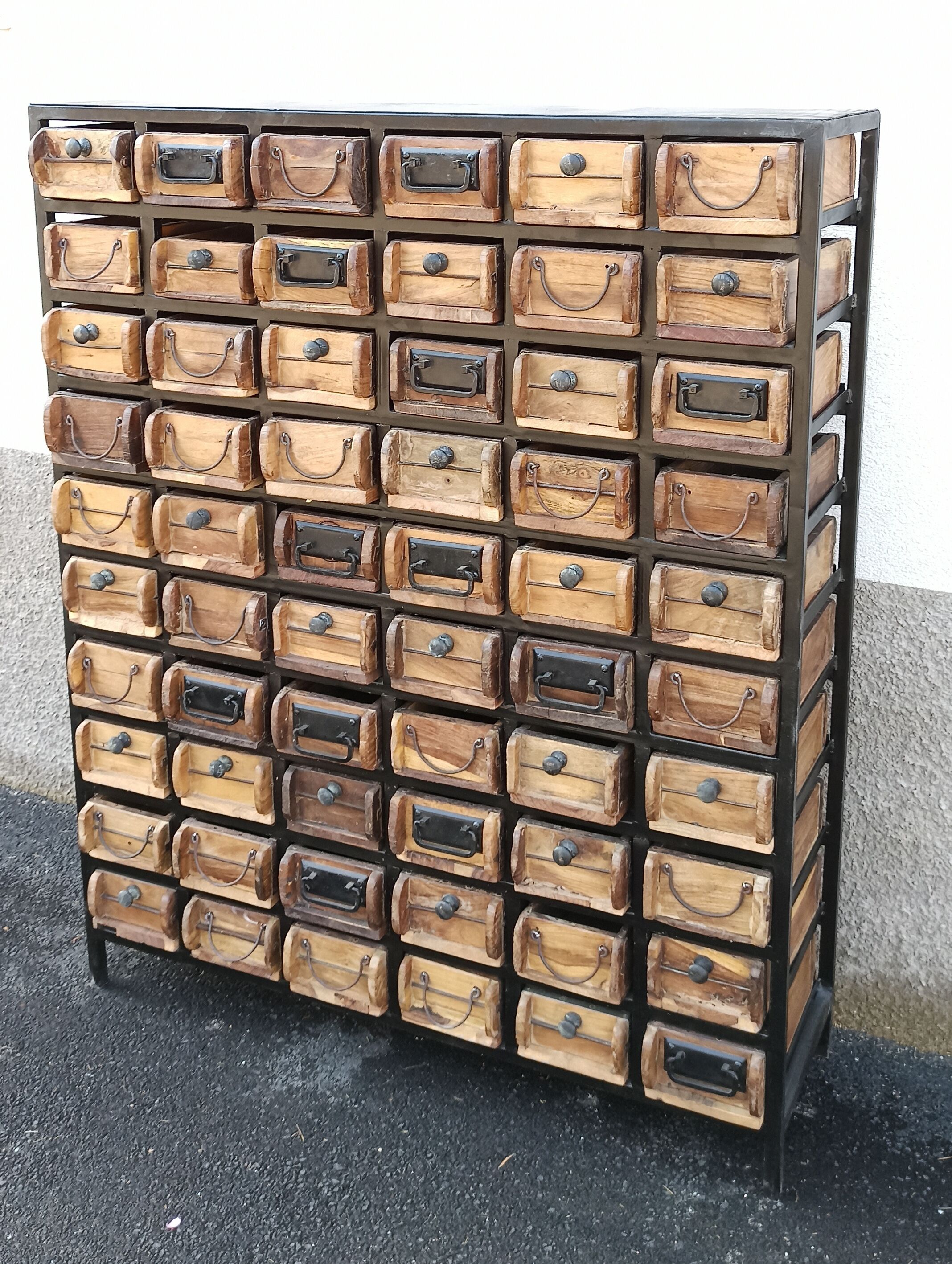 Black metal storage cabinet with 60 wooden drawers