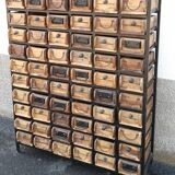 Black metal storage cabinet with 60 wooden drawers