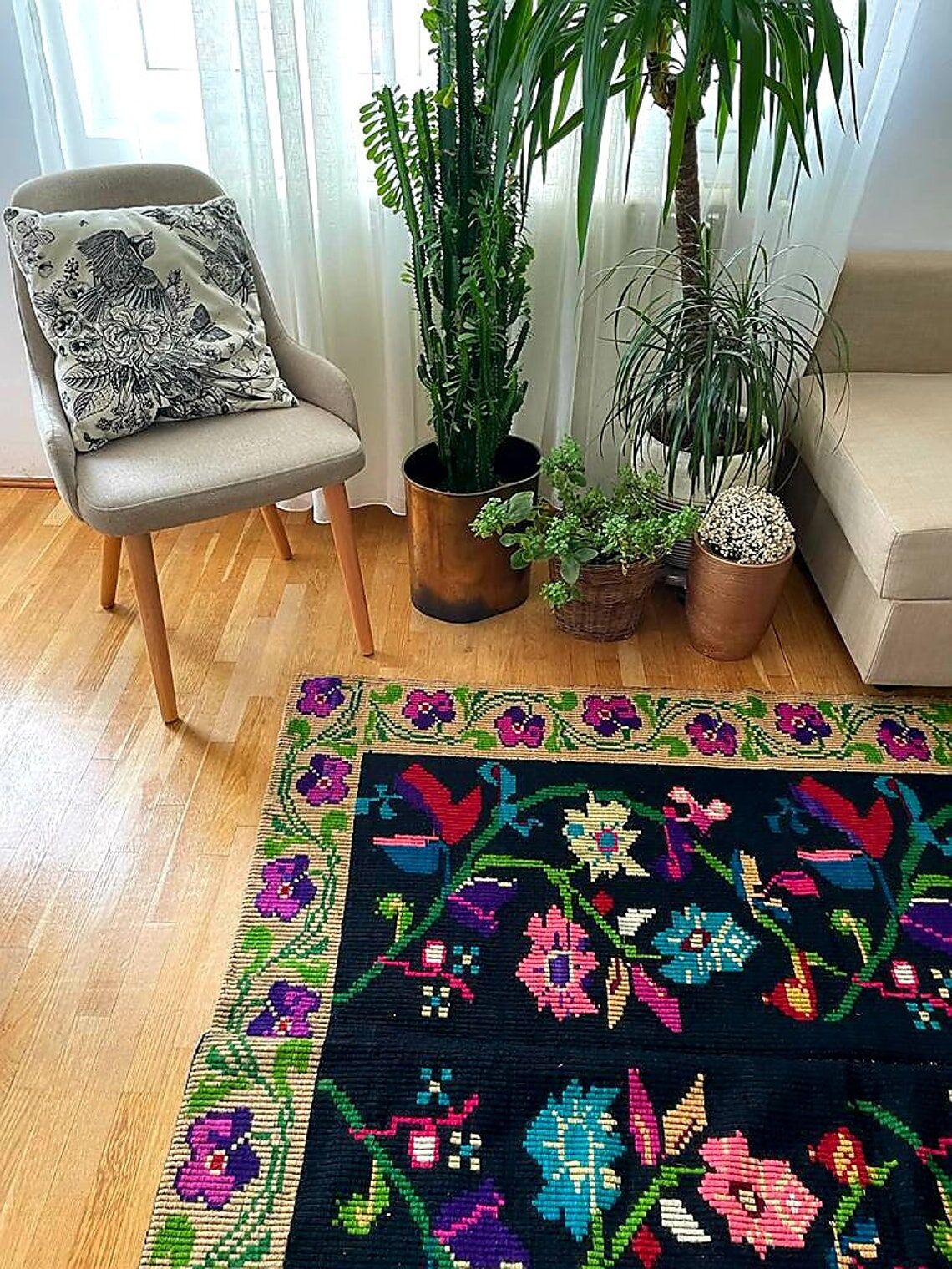 Romanian wool carpet floral design with green border on black background 180x153cm