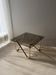 Coffee table with smoked glass and curved metal base