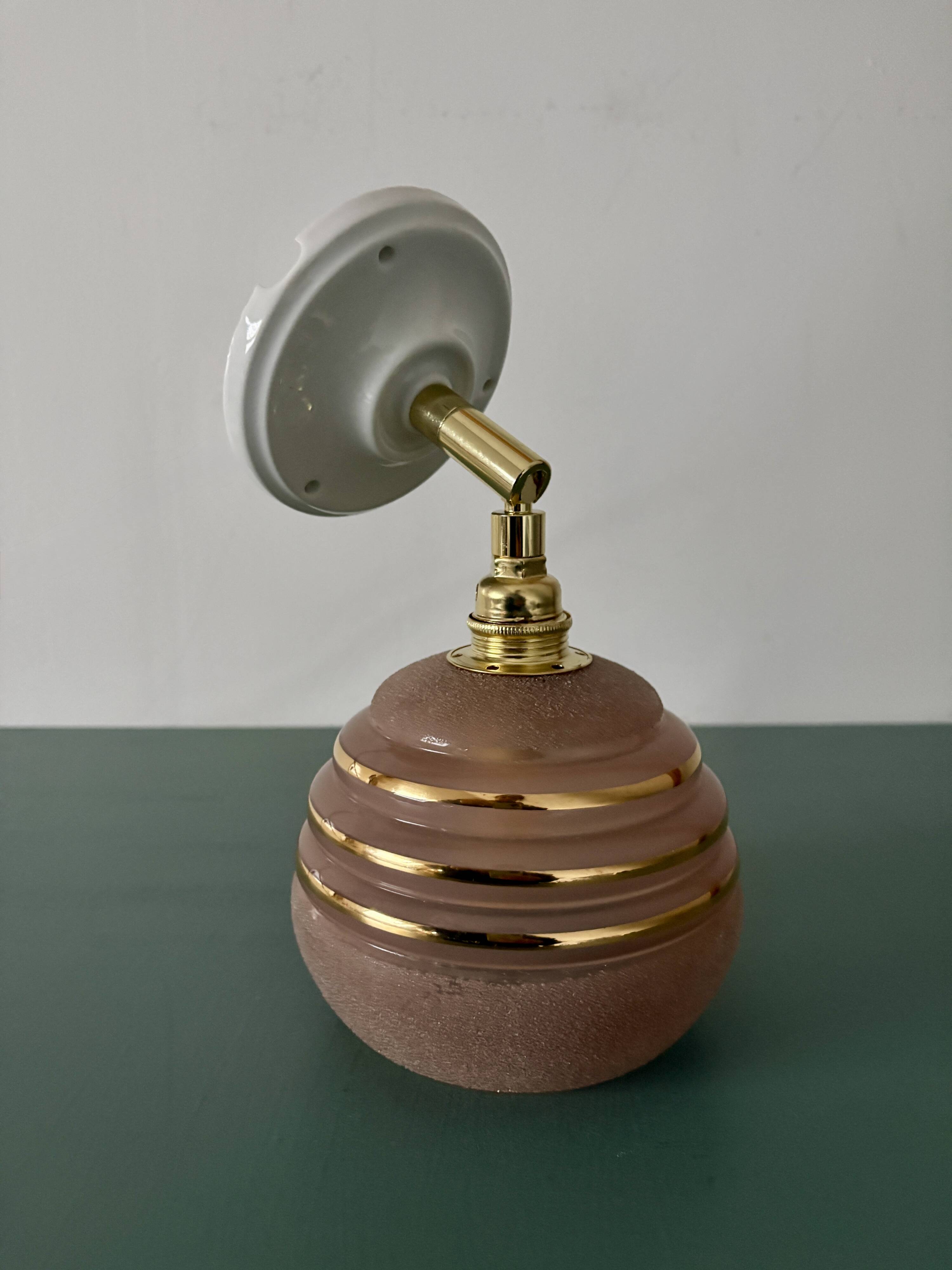 Vintage globe wall light in frosted pink and gold glass.