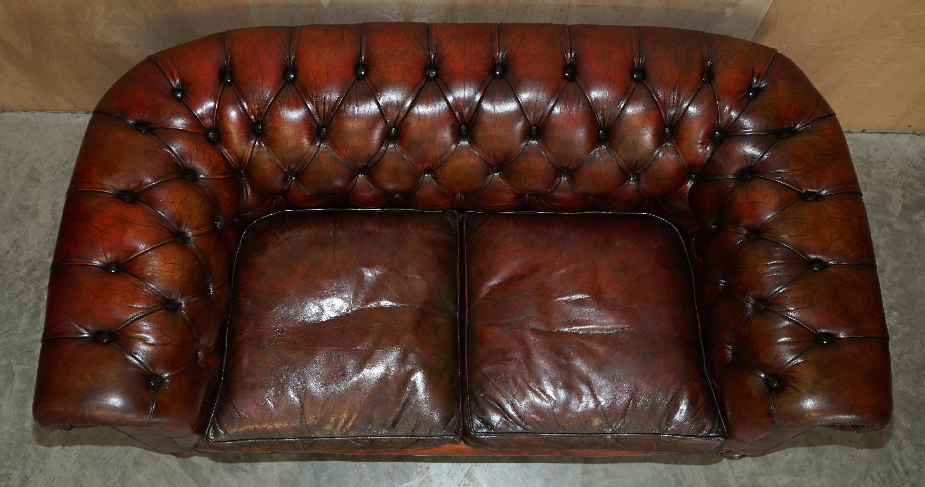 Pair of restored antique Chesterfield sofas in Boudreaux leather.