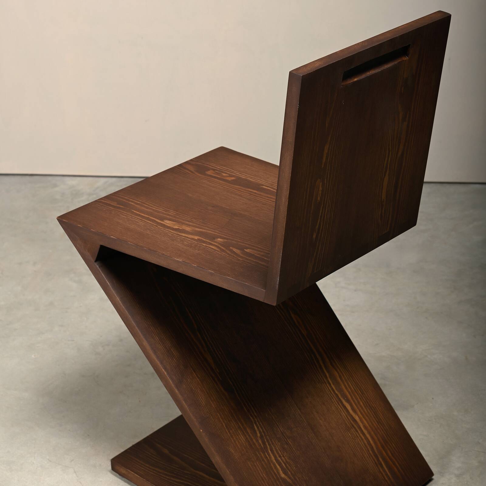 Gerrit Rietveld Zig Zag Chair is dark brown stained wood