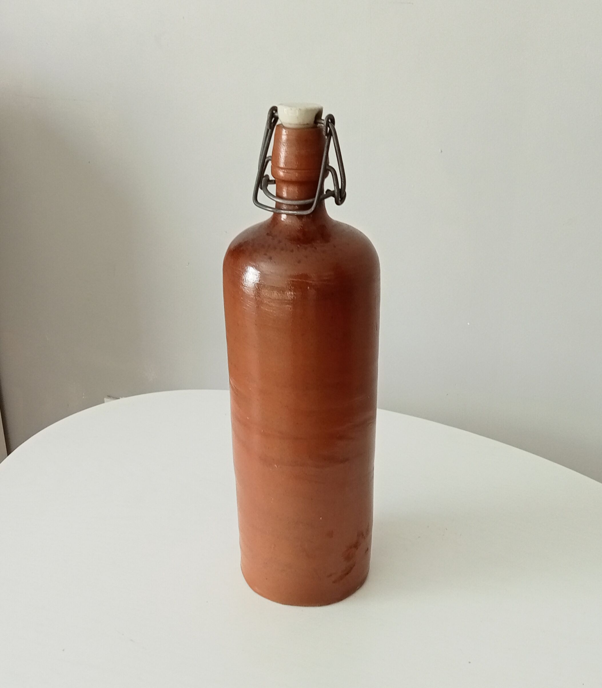 Old bottle in glazed sandstone
