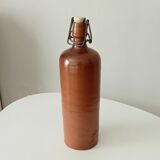 Old bottle in glazed sandstone