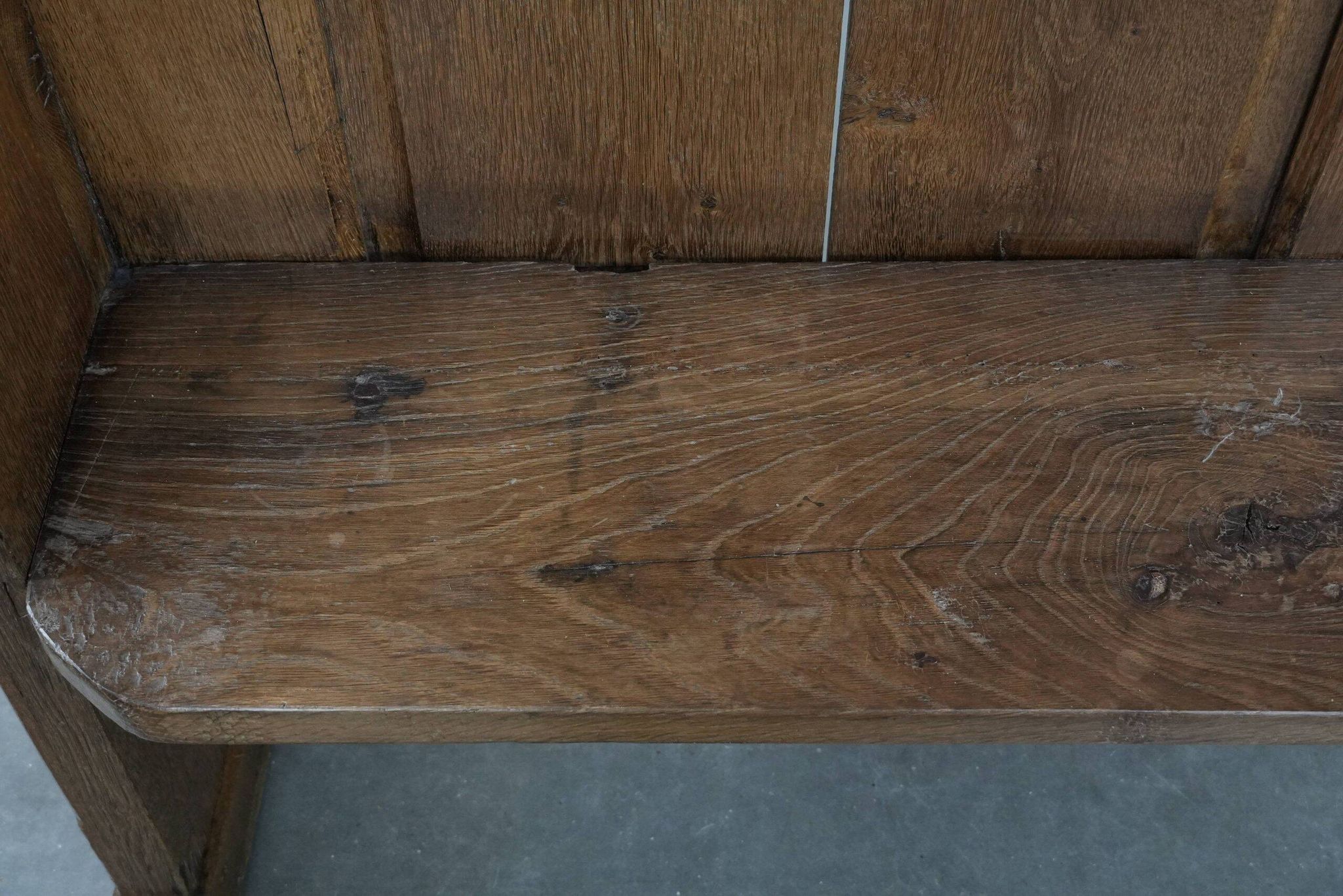 Antique oak church bench in Gothic style with beautiful wood carving