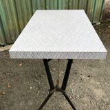 Vintage bistro table with an Art Deco style cast iron base and Formica top.