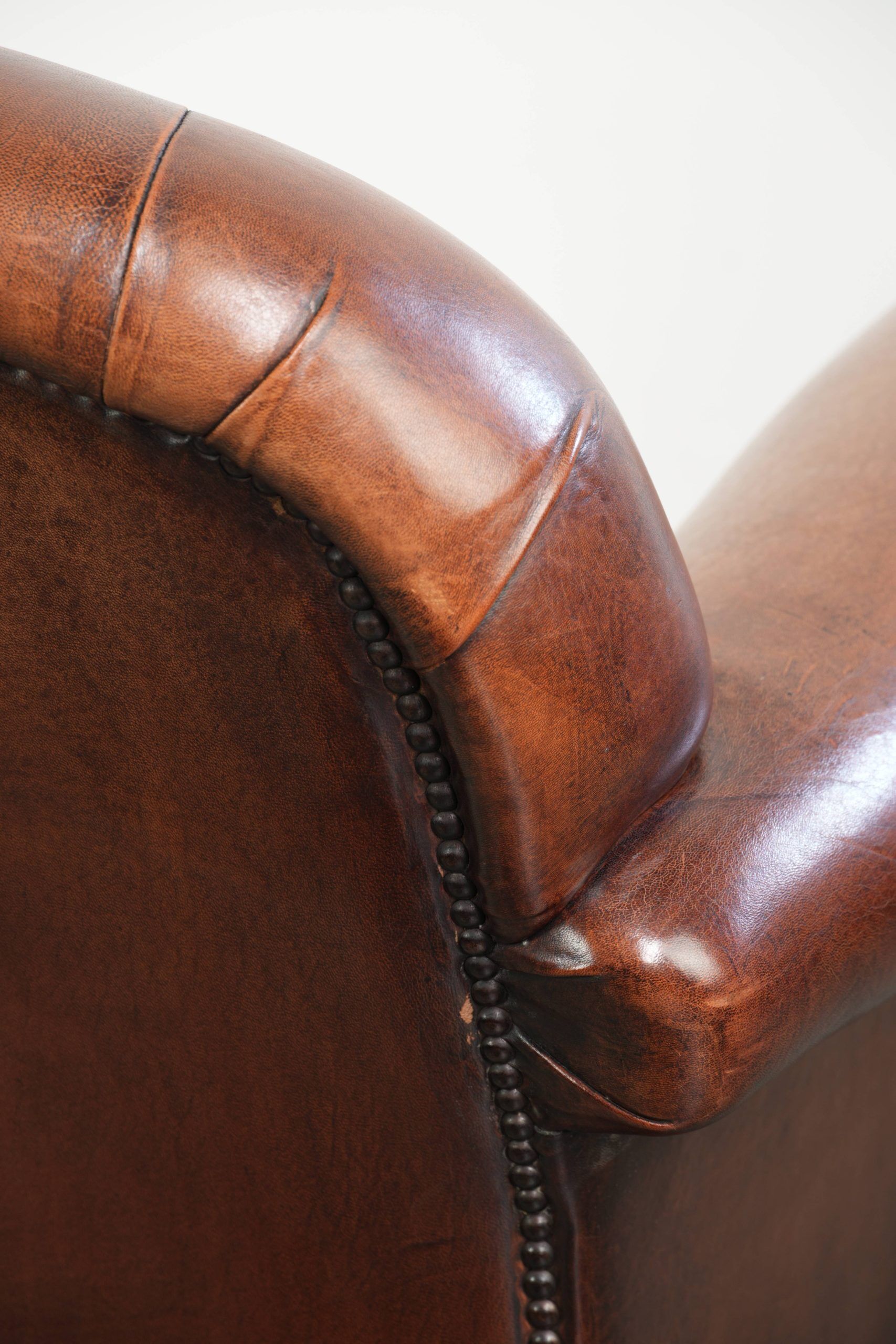 Sheepskin armchair with comfortable seat and finished with decorative nails