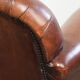 Sheepskin armchair with comfortable seat and finished with decorative nails