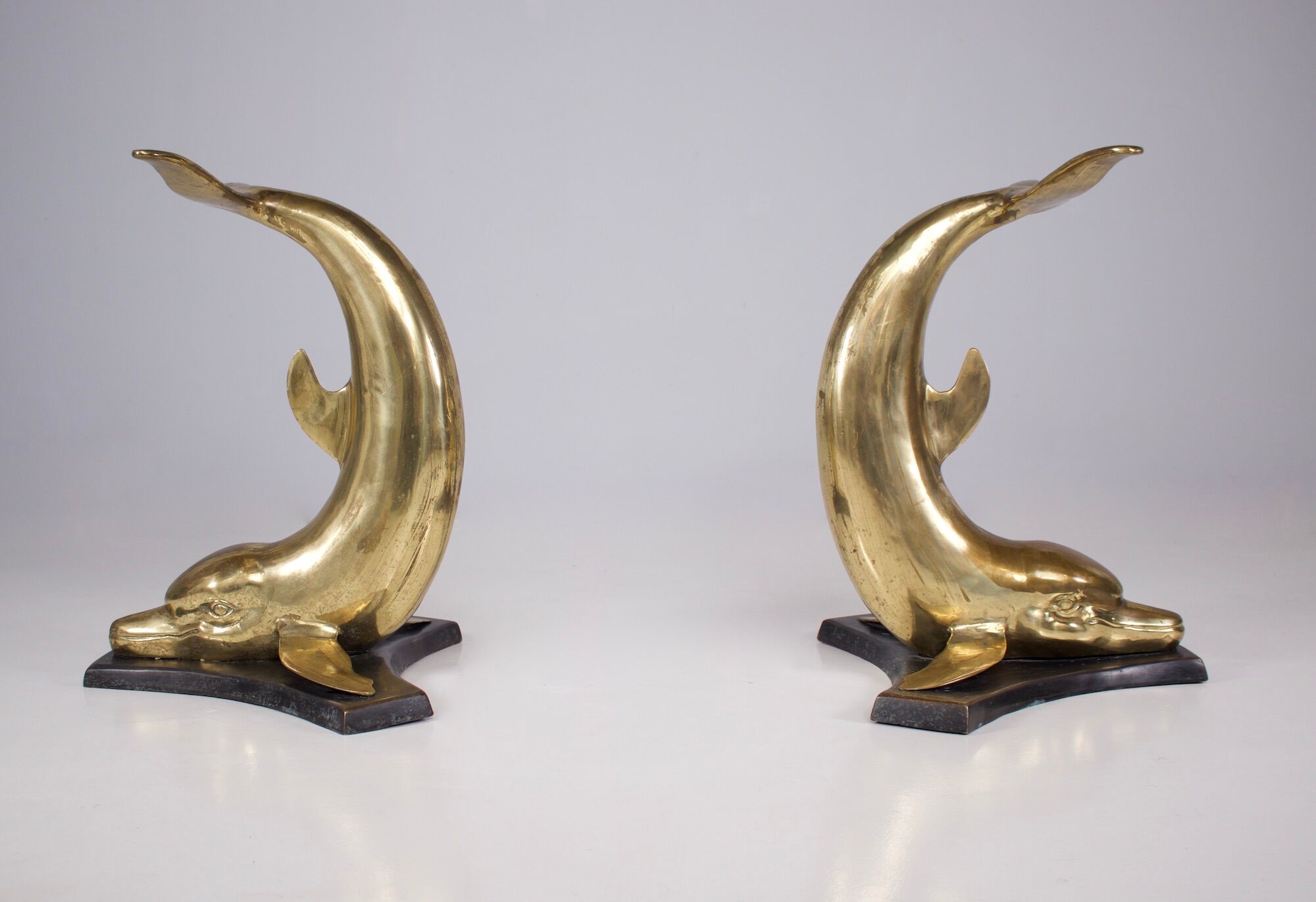 Solid brass dolphin console feet.