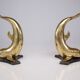 Solid brass dolphin console feet.