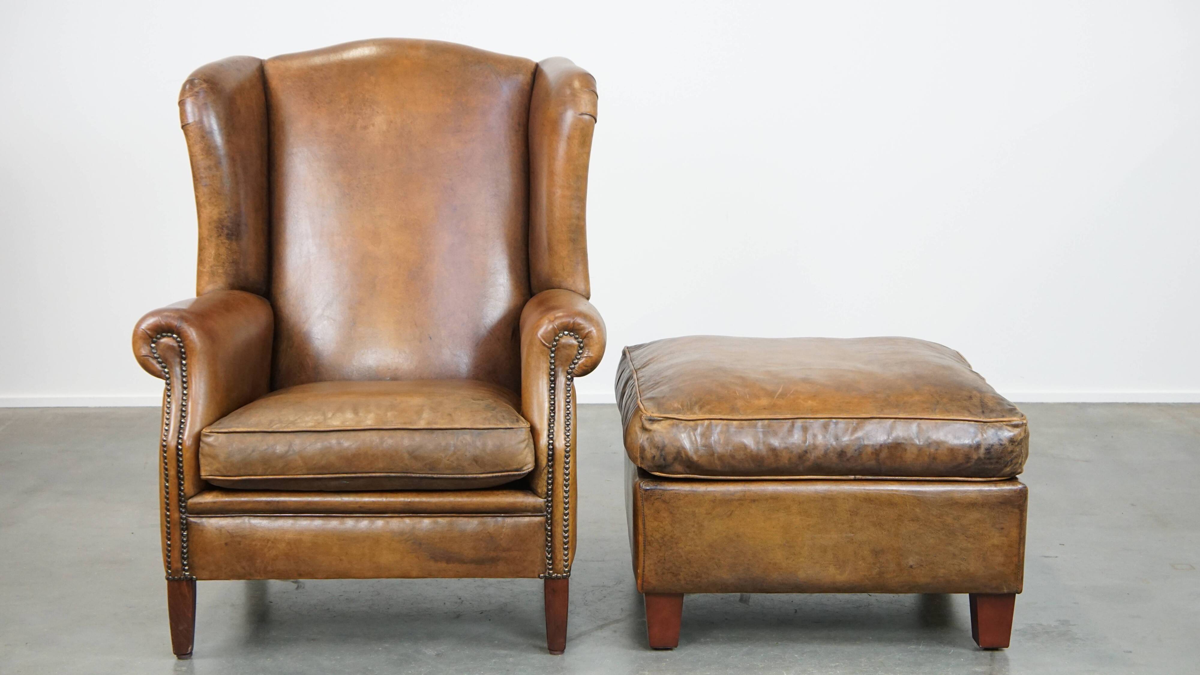 Sheepskin wing chair + XXL patinated footrest