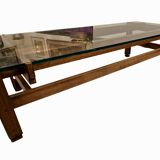 Glass coffee table with a wooden frame.