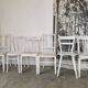 Set of 6 mismatched white chairs