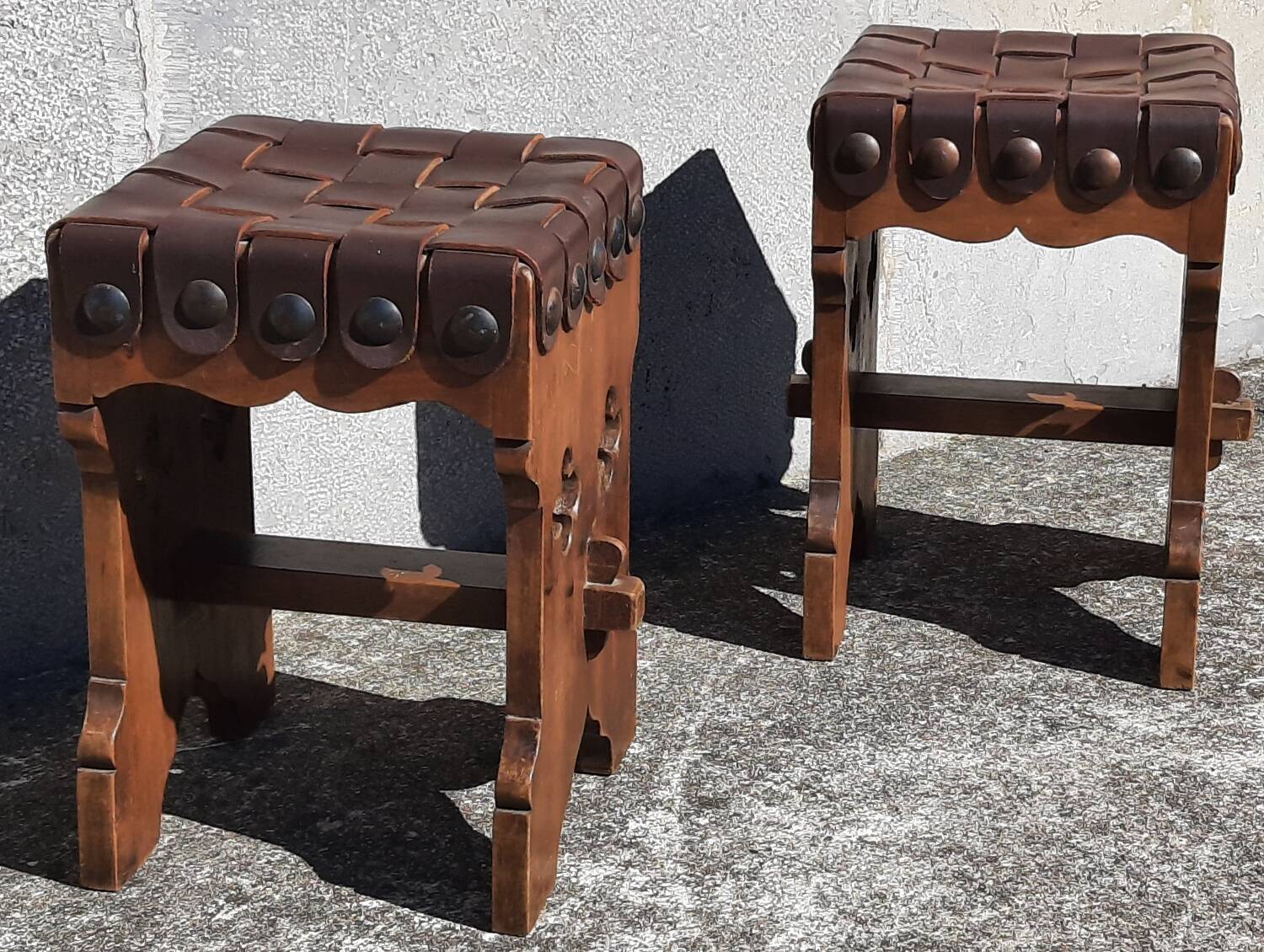 Pair of brutalist stools, leather seat.