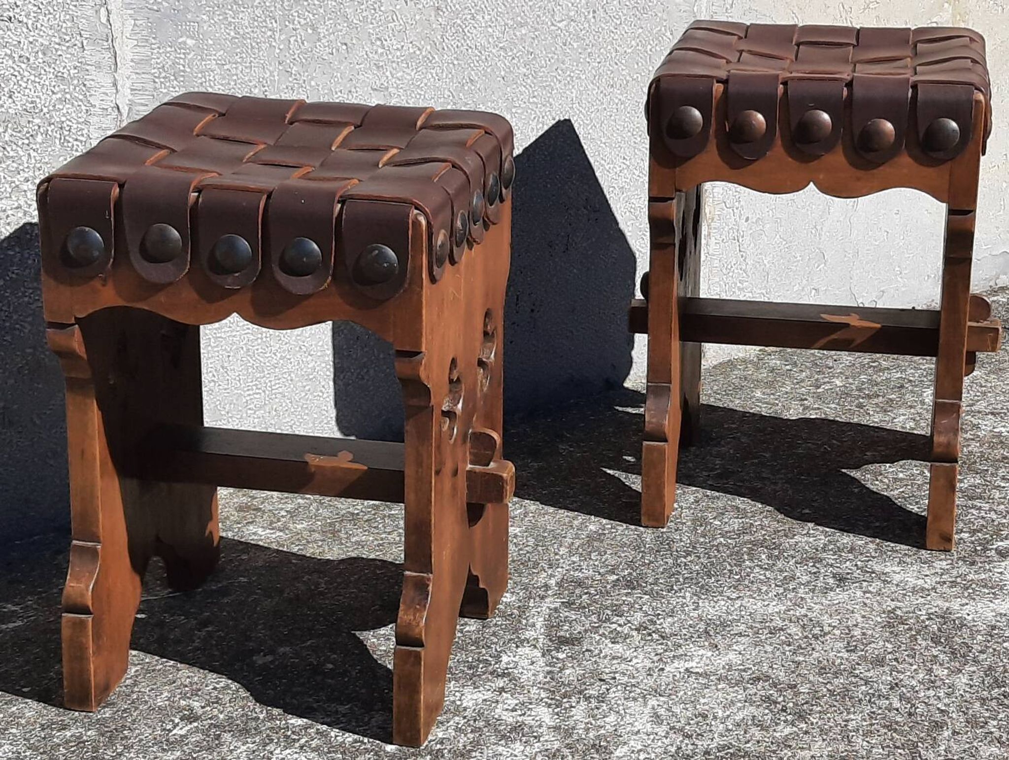 Pair of brutalist stools, leather seat.