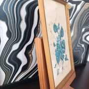 Decorative table with vintage blue flowers in a golden frame.
