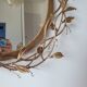 Round mirror in gilded wrought iron and leaves