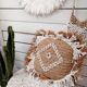 Cushion cover in natural raffia, shells and embroidery in macramé.
