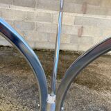 Table with chrome metal legs and smoked glass top.