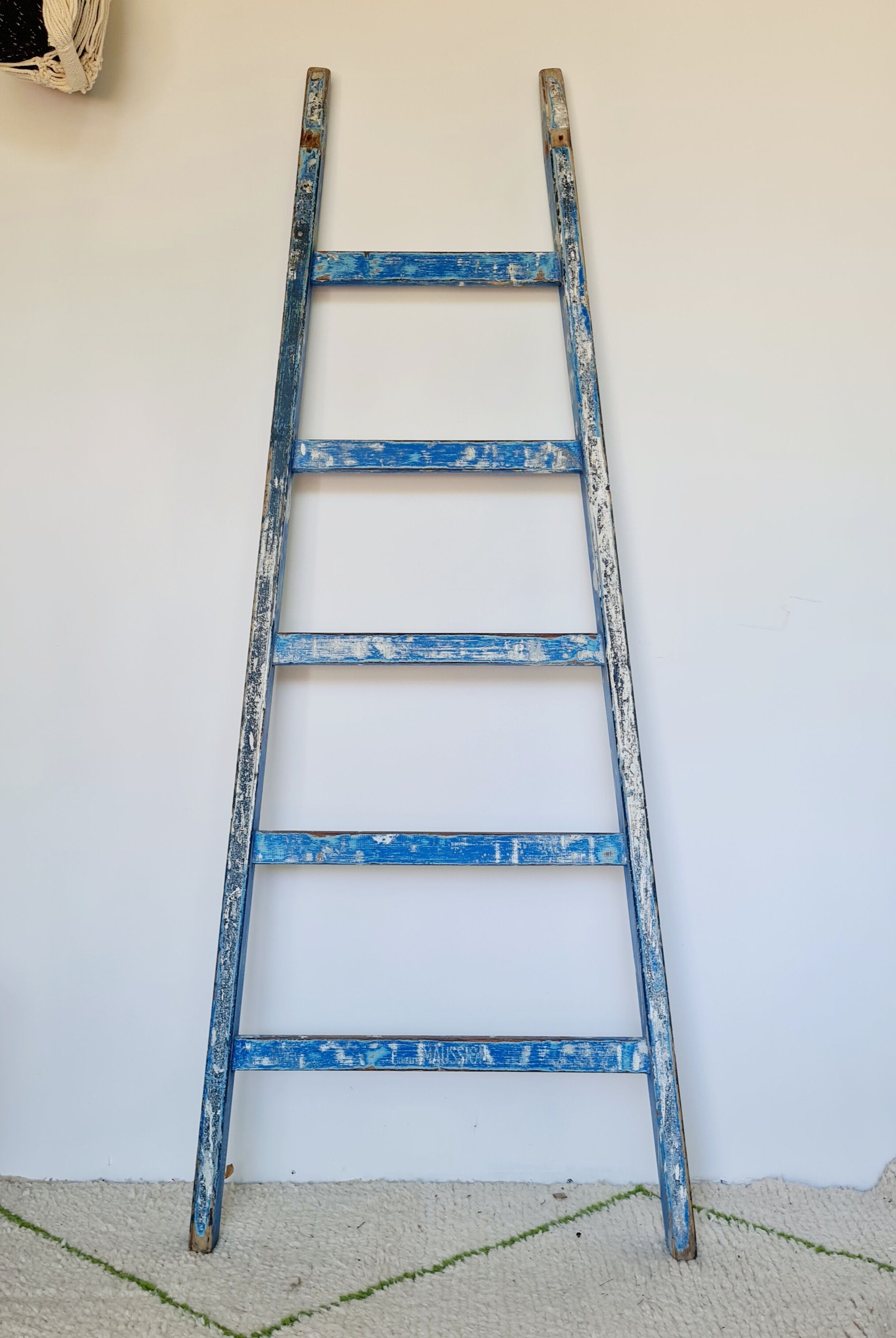 Old ladder in blue wood