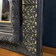 19th-century mirror Napoleon III in blackened wood on a gold background.