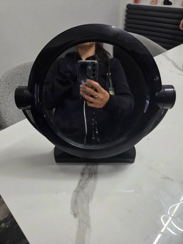 Vintage round pivoting mirror in black, retro style from the 70s/80s.