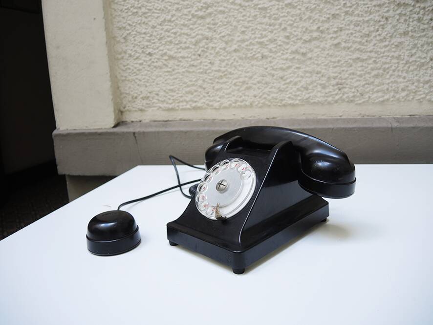 Old ptt phone with rotary dial in black bakelite