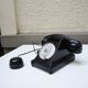 Old ptt phone with rotary dial in black bakelite