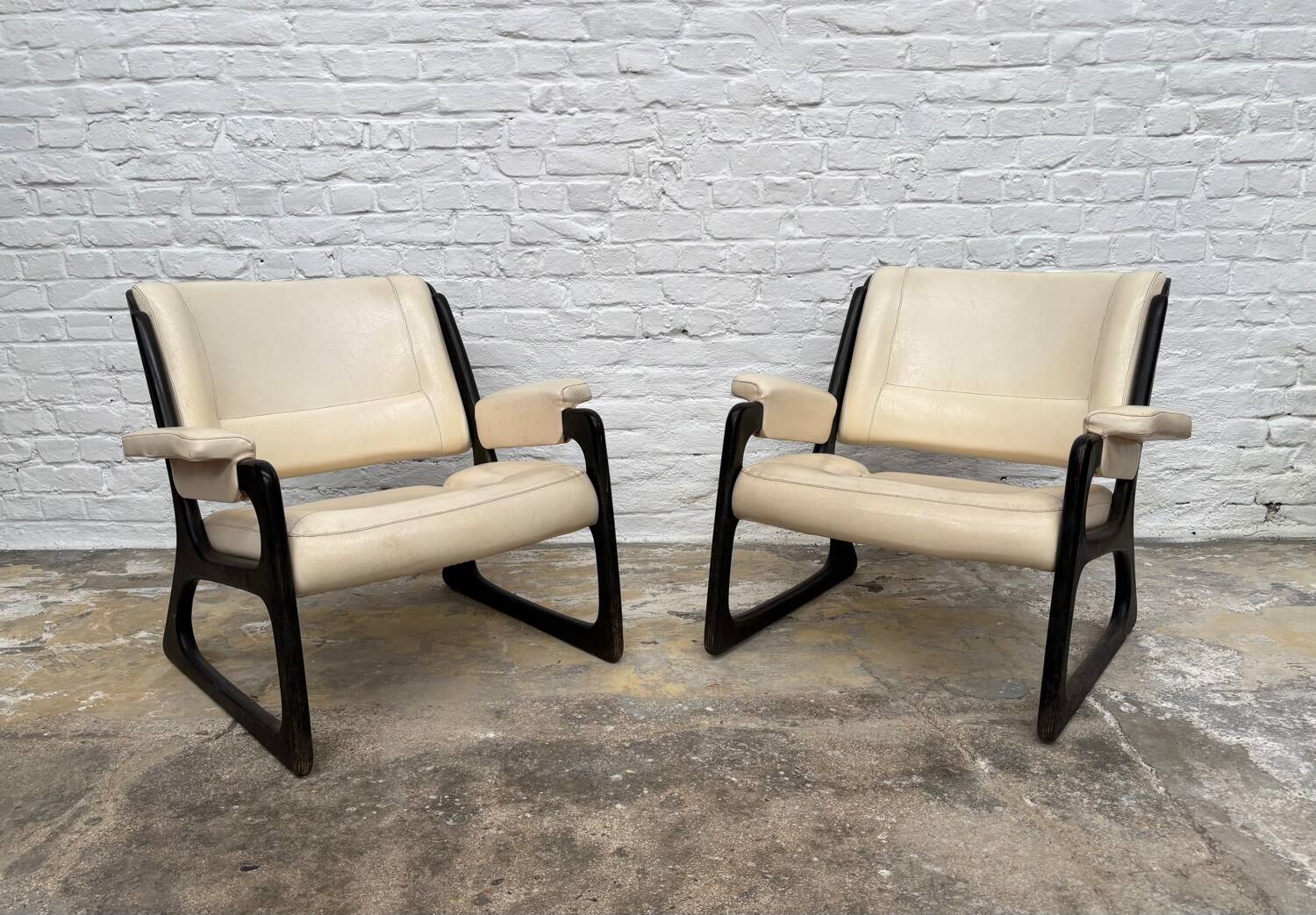 Set of two Baumann sled lounge chairs.