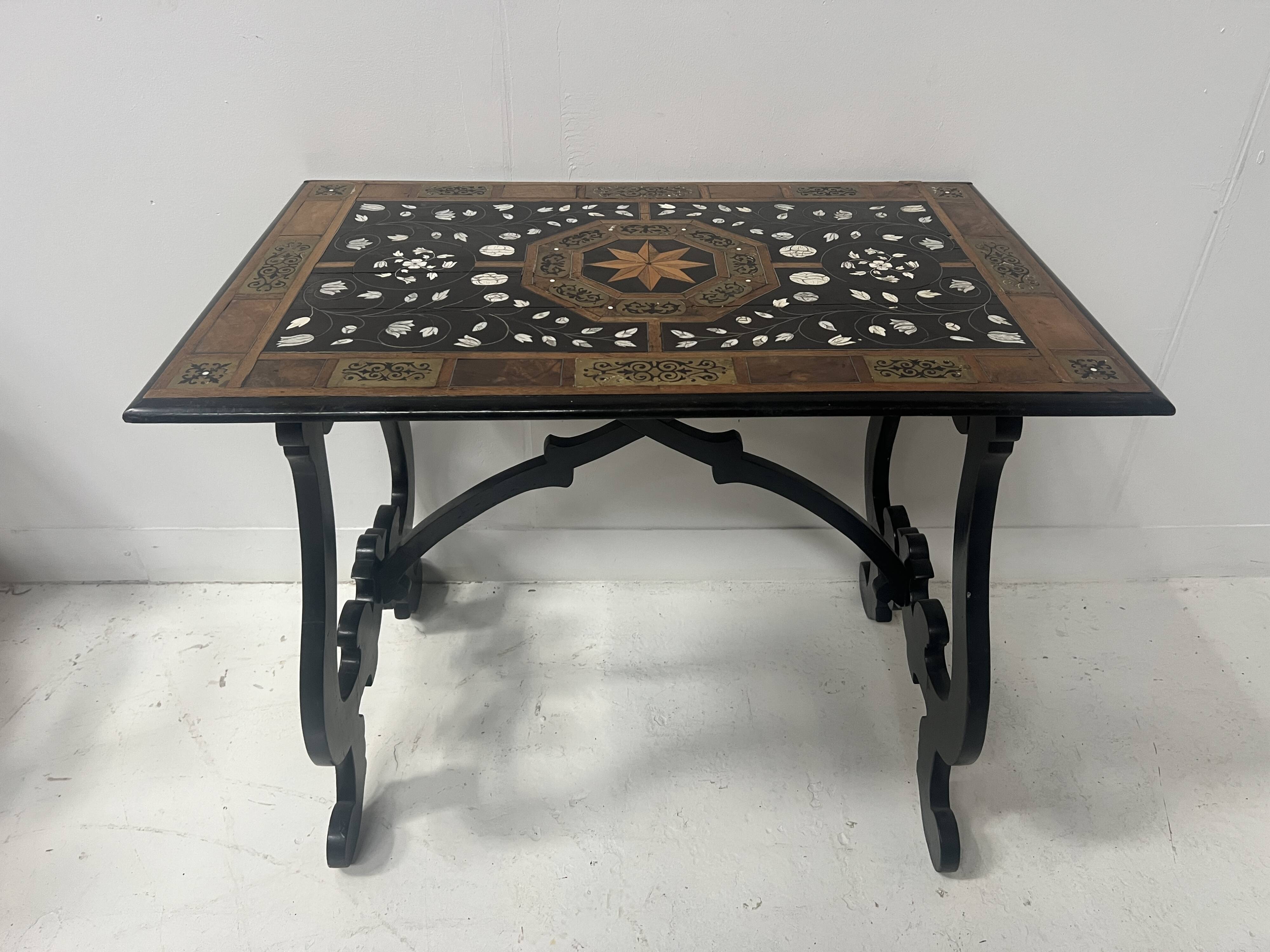 Blackened wood display table with marquetry top, Spain, 19th century.