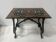 Blackened wood display table with marquetry top, Spain, 19th century.