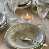 12 speckled ceramic plates.