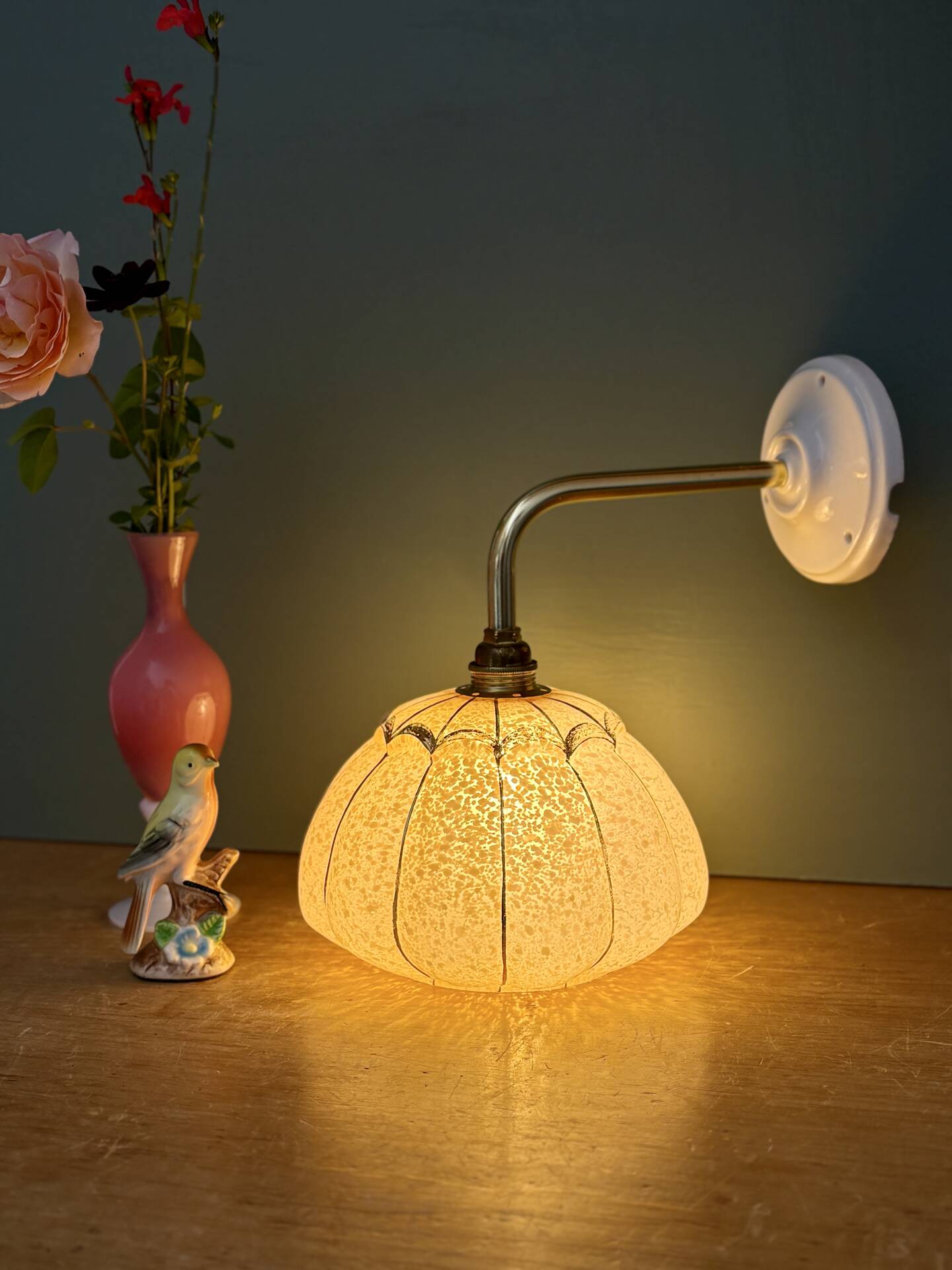 Vintage glass wall light with a pink and gold Clichy globe.