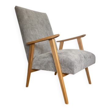 Vintage armchair reupholstered in light grey.
