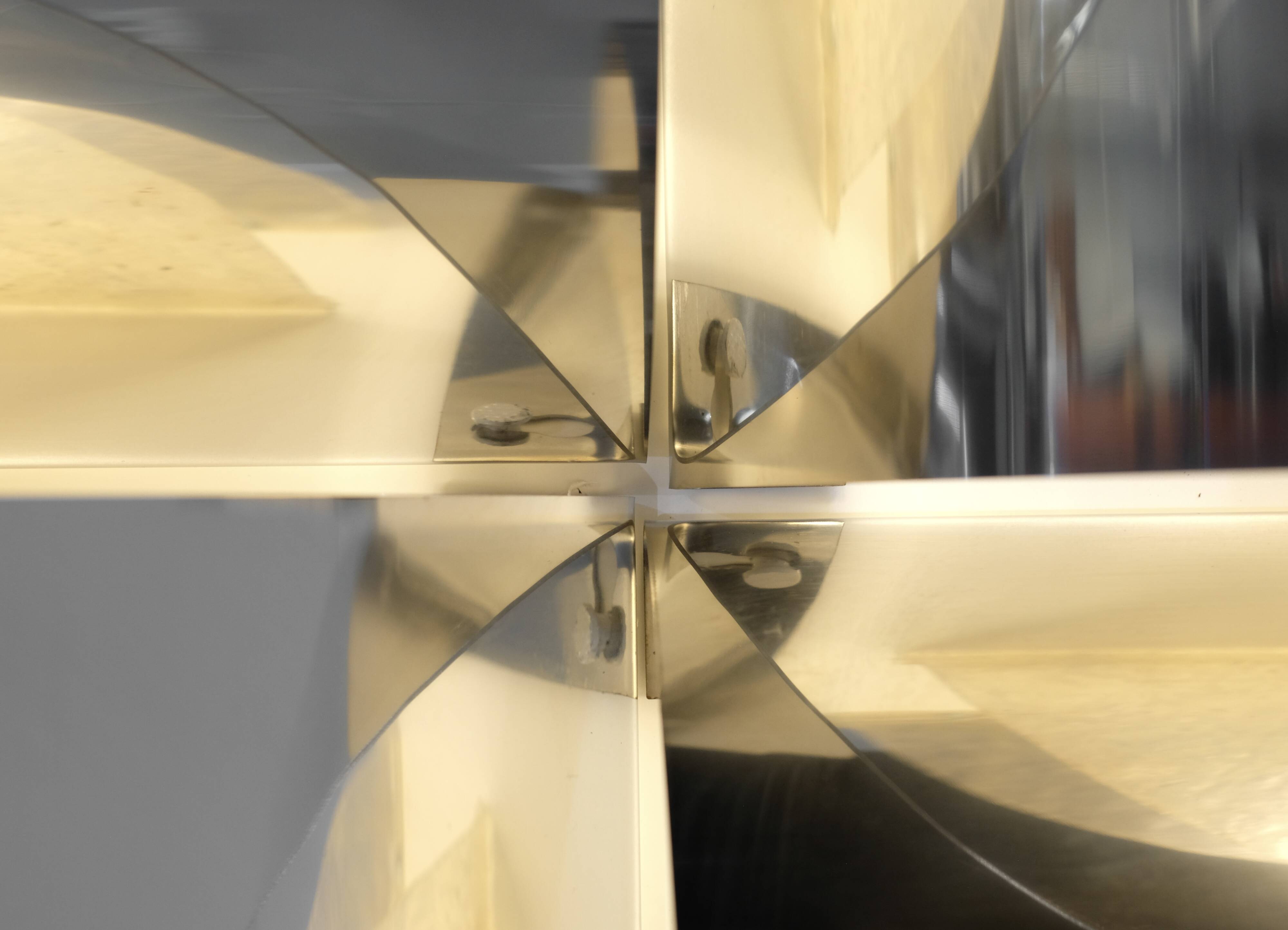 Contemporary wall light in stainless steel and metal.