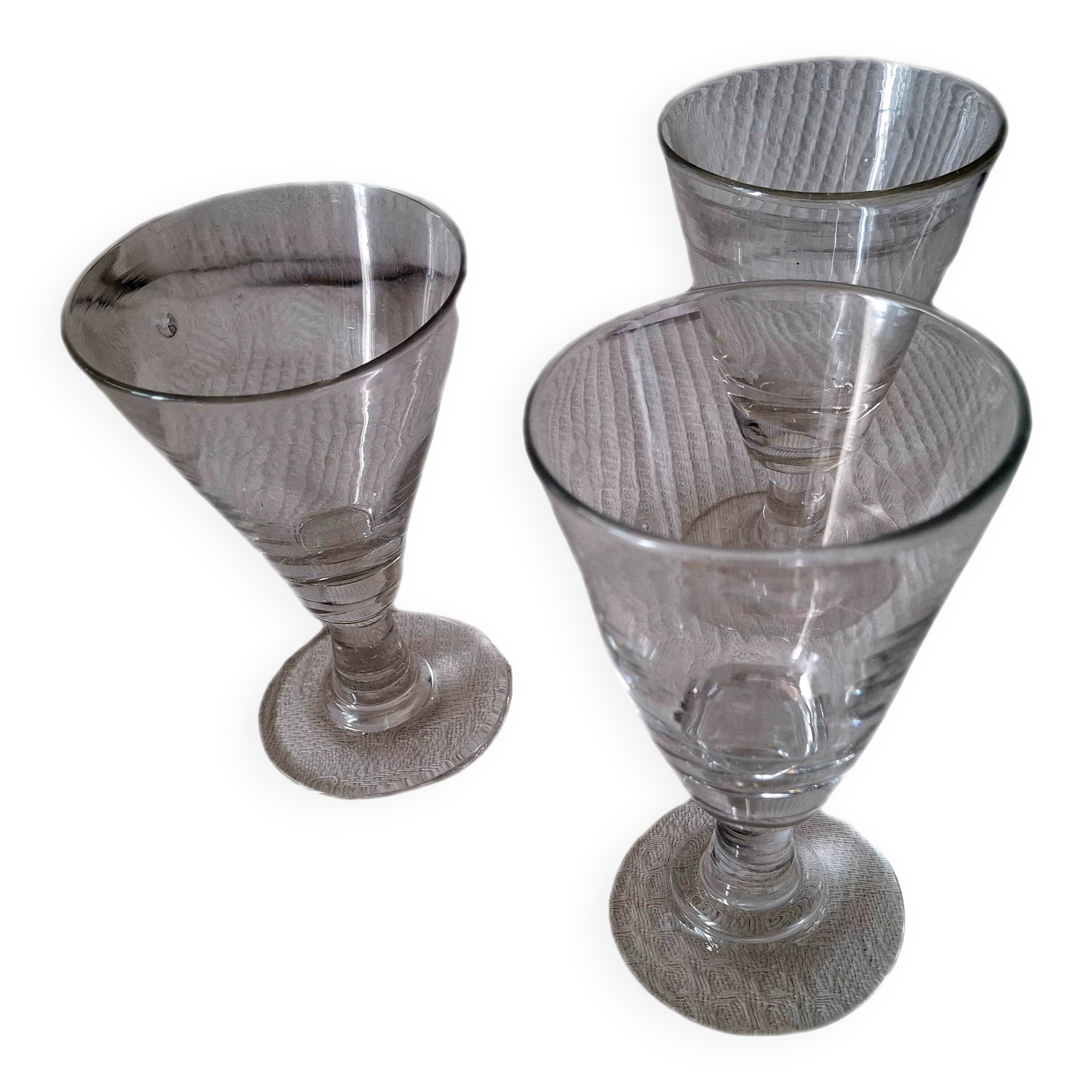 Three conical measuring glasses