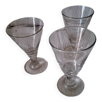 Three conical measuring glasses