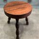 Three-legged stool with beaded wooden legs
