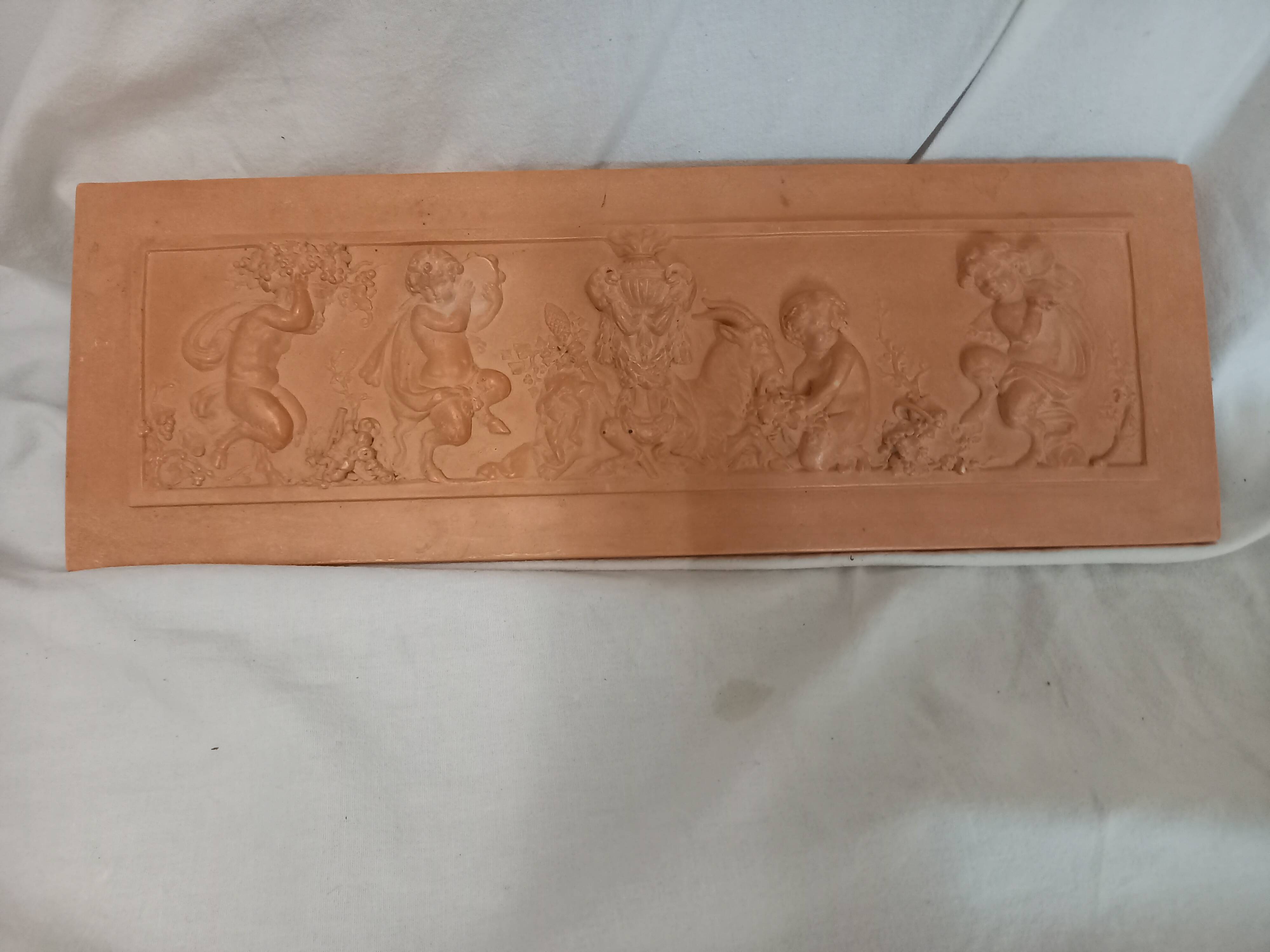 Bas relief, over door, terracotta, children and fauns harvesting grapes