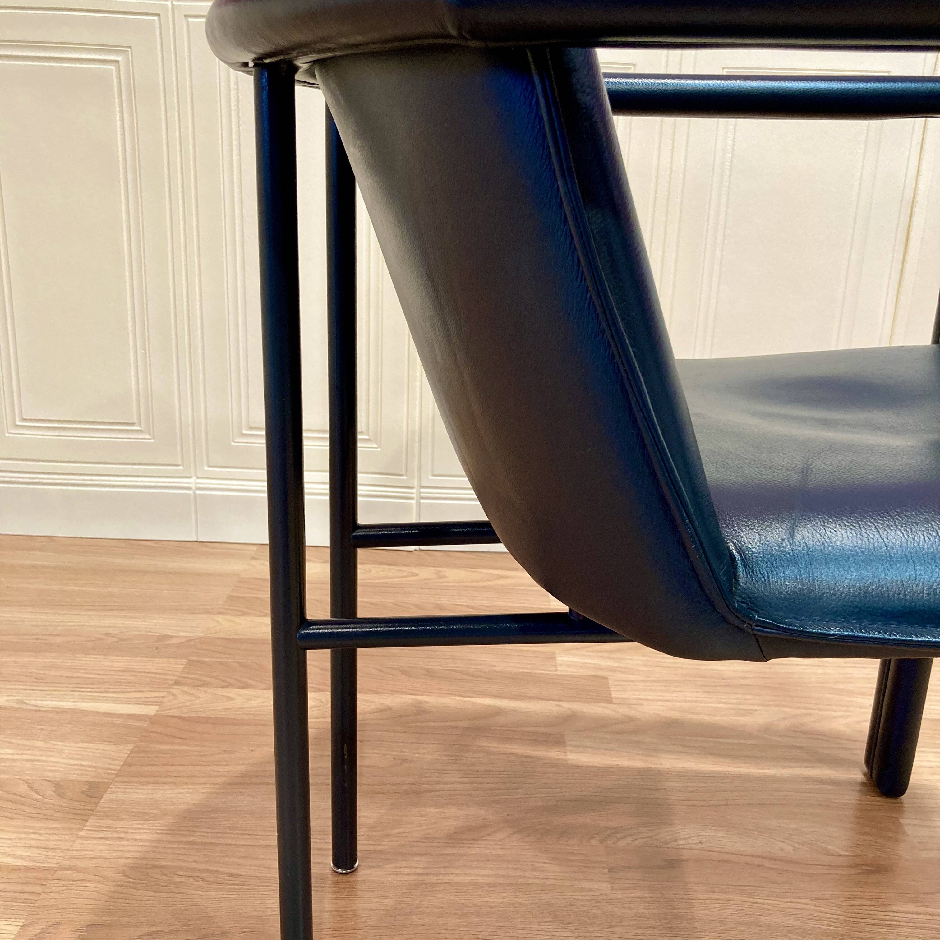 Set of 3 designer leather and metal armchairs.