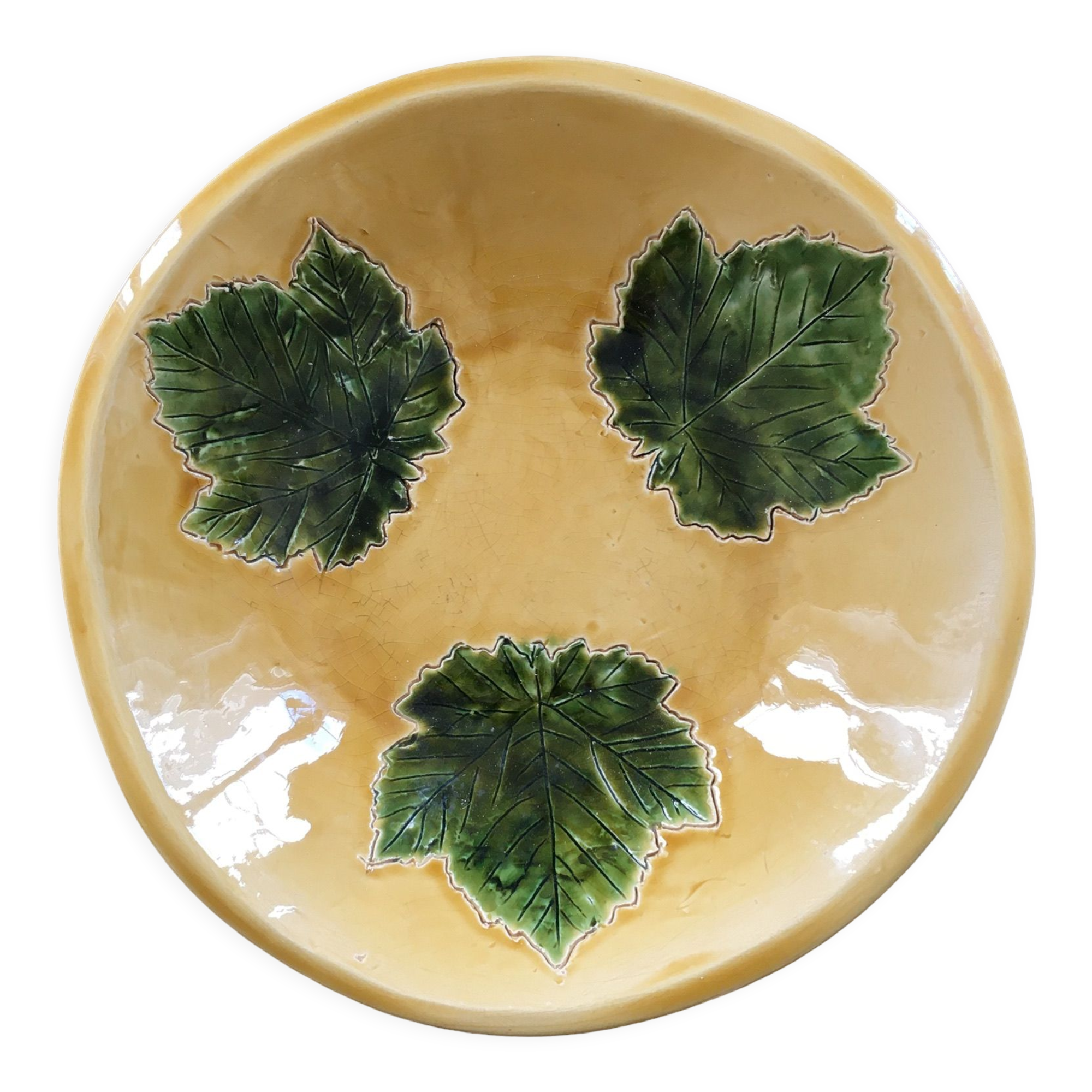 Plate signed with green leaf decoration.