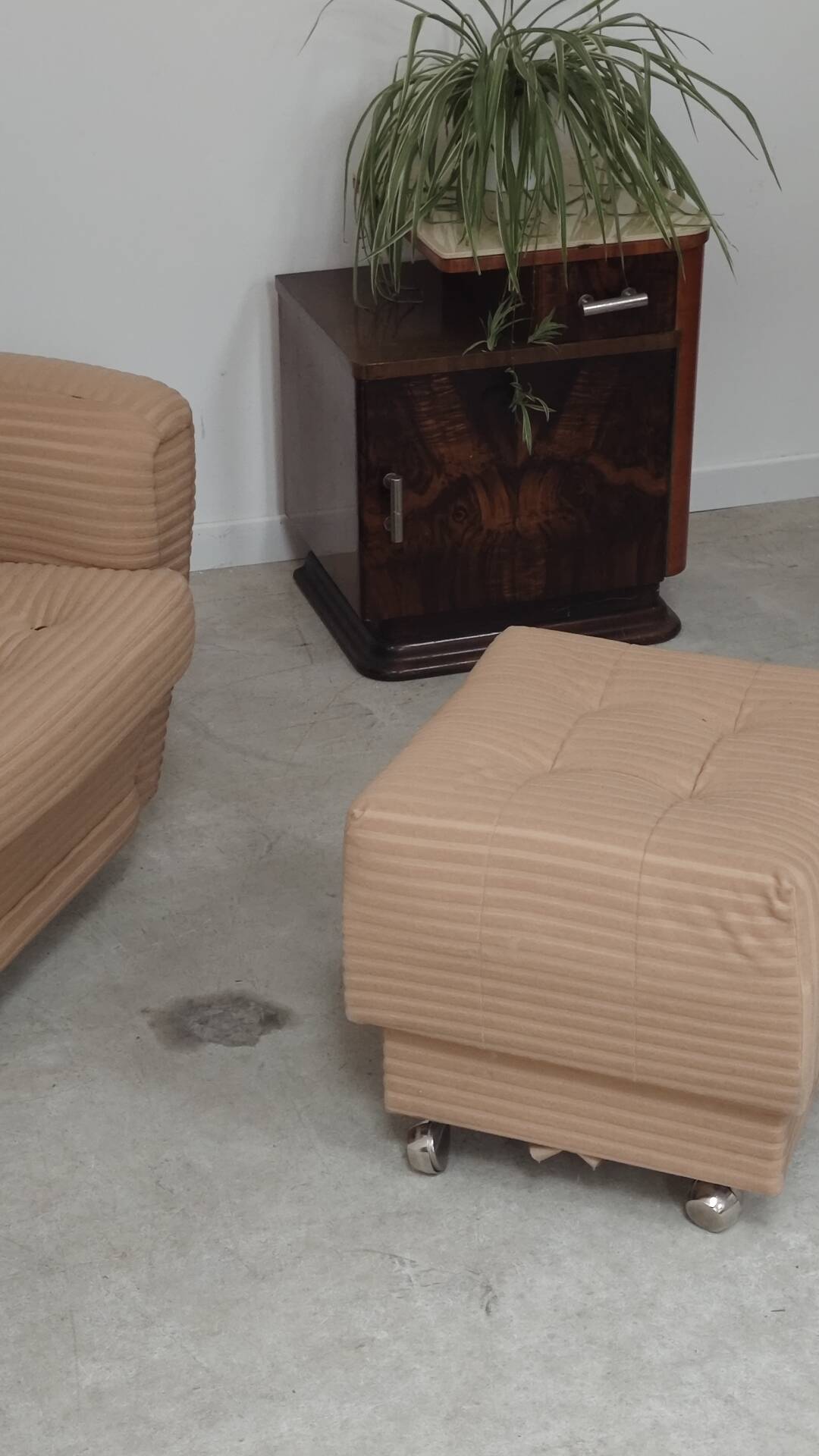Beige wingback armchair and TVAR footrest, former Czechoslovakia.