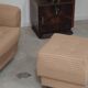 Beige wingback armchair and TVAR footrest, former Czechoslovakia.