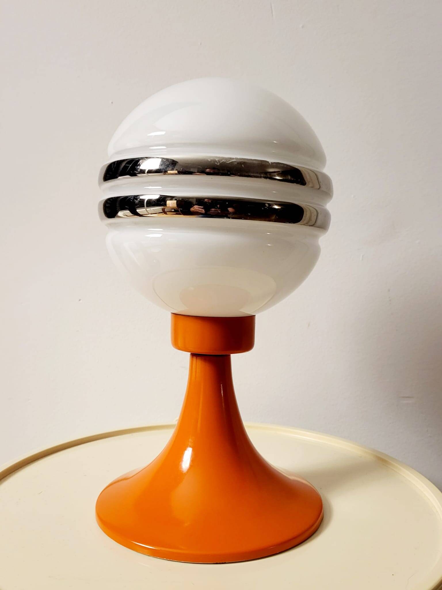 Orange metal and glass table lamp, circa 1960.