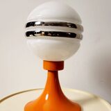 Orange metal and glass table lamp, circa 1960.